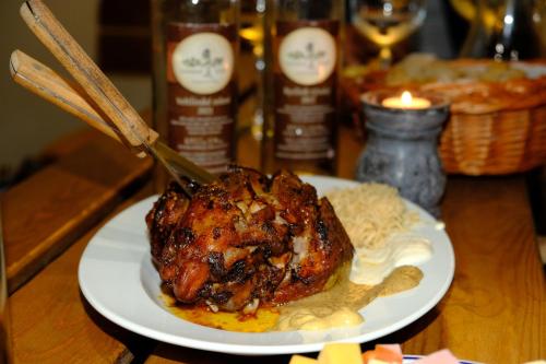 a chicken on a plate with rice and a knife at Privat Bohemia in Šatov