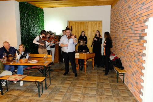 a man standing in a room with a group of people at Privat Bohemia in Šatov