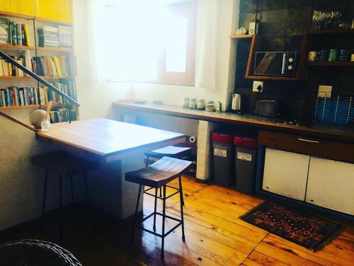 a kitchen with a counter and a table with stools at Stay at Bokkoms in Paternoster Self Catering Accommodation in Paternoster
