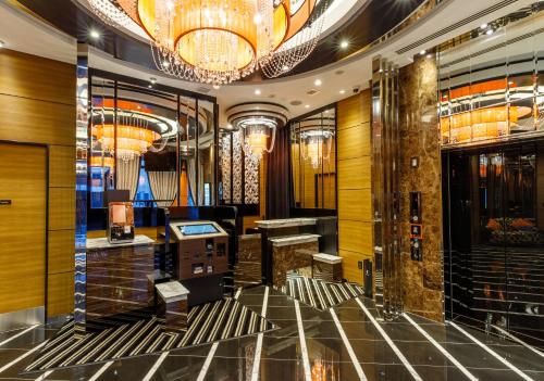a lobby of a hotel with a chandelier at APA Hotel Asakusa Kaminarimon Minami in Tokyo