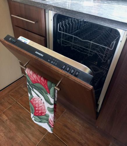 an oven with a towel hanging out of it at Basco River Lodge Luxury Apartment in Grabouw