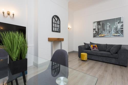 a living room with a glass table and a couch at The Station House in Preston