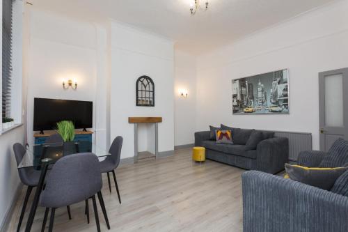 a living room with a couch and a table at The Station House in Preston
