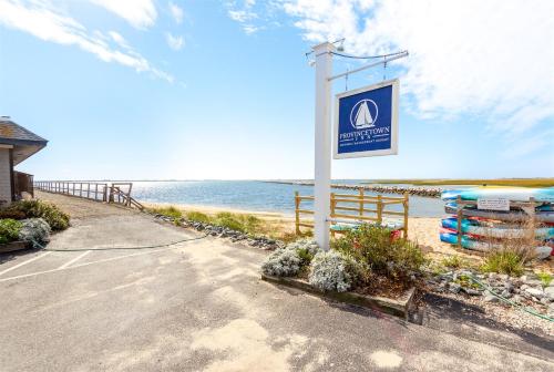 a sign for a beach with the ocean in the background at Provincetown Inn in Provincetown