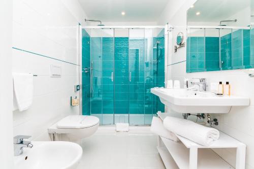 a bathroom with a toilet and a sink and a shower at Hotel Isabella Sorrento in Sorrento