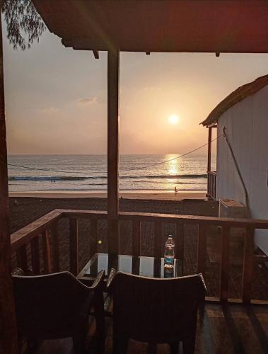 a view of the beach at sunset from a restaurant at Silent Waves in Agonda