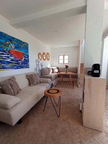 a living room with a couch and a table at Dar YAMAR in Essaouira