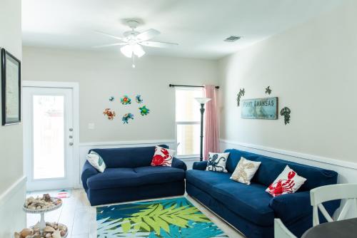 a living room with a blue couch at Soulshine in Port Aransas