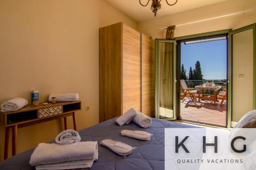 a bedroom with a bed with a view of a patio at Villa Elaionas 1 Experiencing nature's tranquility! in Svoronata