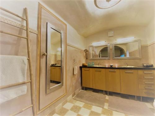 a bathroom with a sink and a mirror at Villa Elva in Le Plan-de-la-Tour