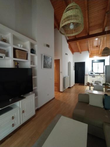a living room with a large flat screen tv at Adosado de María - Para 4 pax en Posada de Llanes in Llanes