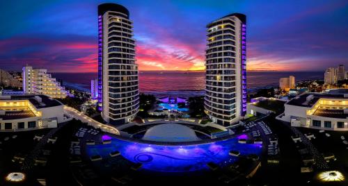 a view of two tall buildings at night at The Capital Pearls Hotel in Durban