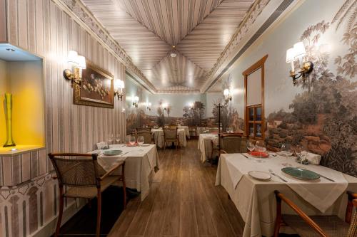 a dining room with tables with white table cloth at RuinAdalia Hotel - Adult Only in Antalya