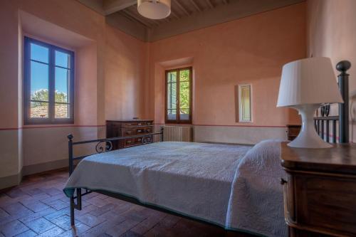 a bedroom with a bed and a lamp and windows at Villa Lama by Mmega in Lama