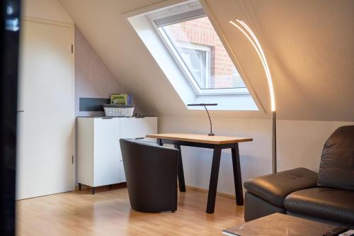 a small room with a table and a window at Luxury Apartment Kampe in Stemwede