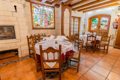 a dining room with tables and a stained glass window at Hotel Santo Domingo de Silos in Santo Domingo de Silos