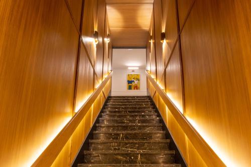 a hallway with wooden walls and stairs with lights at Best Western Plus Casablanca City Center in Casablanca
