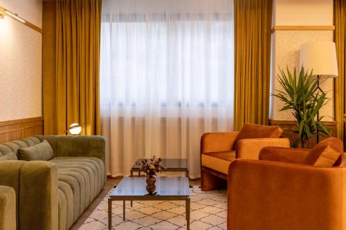 a living room with a couch and chairs and a window at Best Western Plus Casablanca City Center in Casablanca