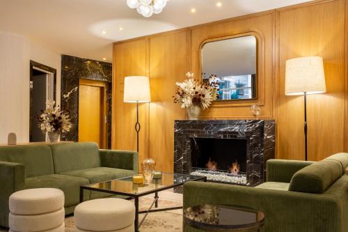 a living room with a fireplace and green furniture at Best Western Plus Casablanca City Center in Casablanca