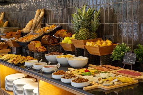 a buffet filled with lots of different types of food at Best Western Plus Casablanca City Center in Casablanca