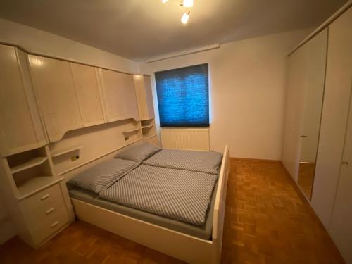 a small bedroom with a bed and a window at Apartment 2 Feistriz in Rosental 9181 in Feistritz im Rosental