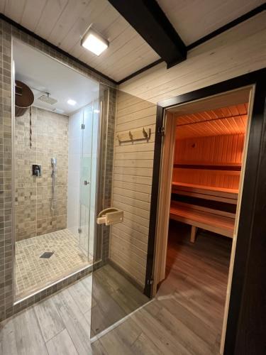a bathroom with a shower and a walk in shower at Villa Family House Truskavets in Modrychi