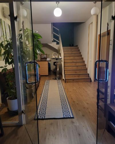 a hallway with stairs and a rug on the floor at Hotel Rural Luna Llena in Torremocha de Jarama
