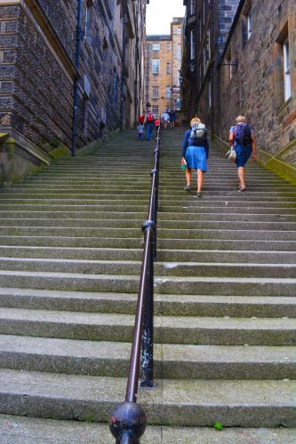 two women walking up the stairs in an alley at The Inn Place in Edinburgh