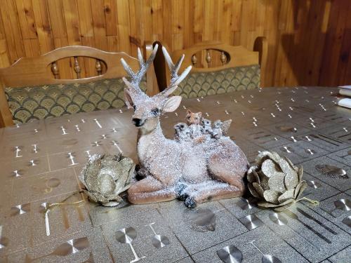 a statue of a deer sitting on a table at Szilvásváradi Kemencés Apartmanok in Szilvásvárad