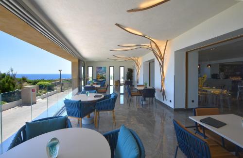 a restaurant with tables and chairs and a balcony at Santateresa in Bonifacio