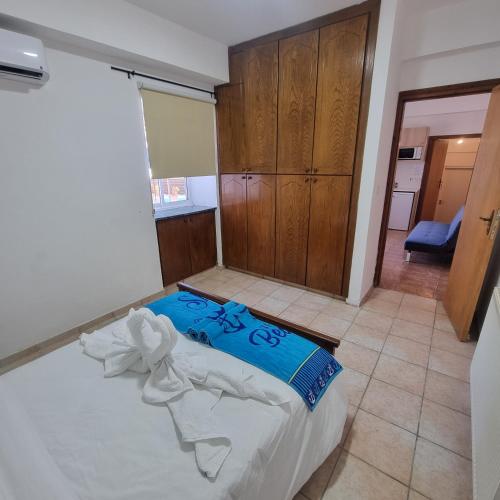 a bedroom with a bed in a room with wooden cabinets at Potamos Private Suites in Paphos City