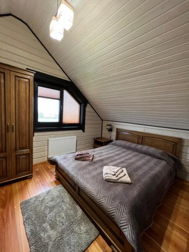 a bedroom with a large bed in a attic at Villa Family House Truskavets in Modrychi