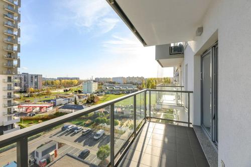 an apartment balcony with a view of a parking lot at Albatross Tower - apartament w centrum Przymorza by Grand Apartments in Gdańsk