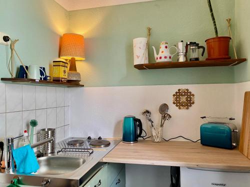 a kitchen with a sink and a counter top at Appartement Buntspecht in Erfurt