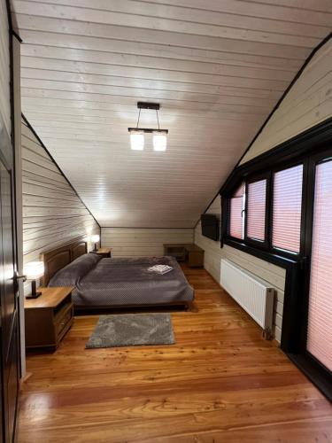 a bedroom with a bed in a attic at Villa Family House Truskavets in Modrychi