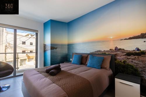 a bedroom with a bed with a rainbow on the wall at High-End central APT with comfy BED & Super WIFI by 360 Estates in San Ġwann