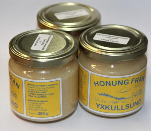two jars of honey sitting next to each other at Yxkullsund Säteri B&B - Manor & Estate since 1662 in Lagan