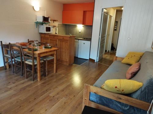 Cette chambre comprend une cuisine et une table avec un lit. dans l'établissement Studio lumineux 6 pers, skis aux pieds, proche commerces, palais des sports à 5 min - FR-1-262-104, à Forest des Baniols