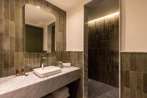 a bathroom with a sink and a mirror at Best Western Plus Casablanca City Center in Casablanca