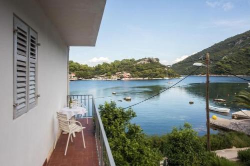 a balcony of a house with a view of a lake at Apartments Paolo in Maranovići