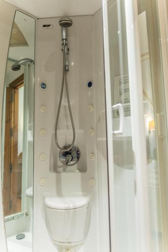 a bathroom with a toilet and a shower at Hotel Santo Domingo de Silos in Santo Domingo de Silos