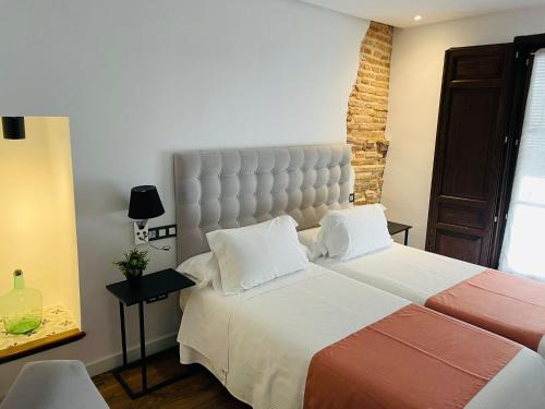 a bedroom with a large bed with a large headboard at Hotel QB Almagro Centro in Almagro