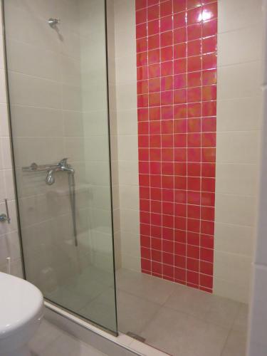 a bathroom with a shower with red tile at Amaryllis in Plataniás