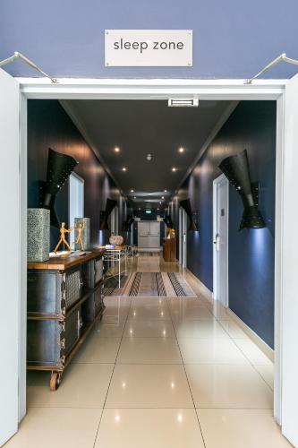 a hallway with a sign that reads sleep zone at Zzzone Boutique Hostel in Hermanus