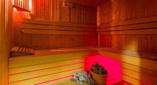 a small sauna with a pink light in it at Rezydencja Korab in Międzyzdroje