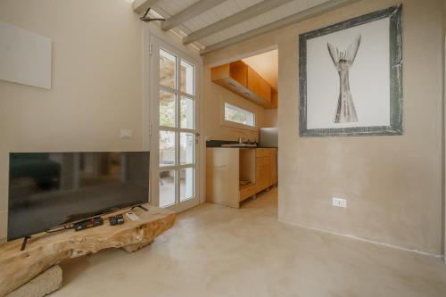 a living room with a flat screen tv next to a window at Villa Elicriso Charme e Nature - Goelba in Portoferraio