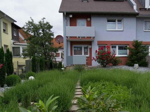 a house with a yard with tall grass at Hotel Neckartal in Köngen
