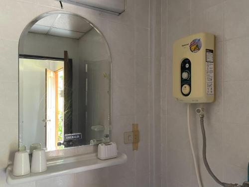 a bathroom with a mirror and a soap dispenser at The Creek Garden Resort Huainamrin ห้วยนำ้ริน in Mae Hong Son