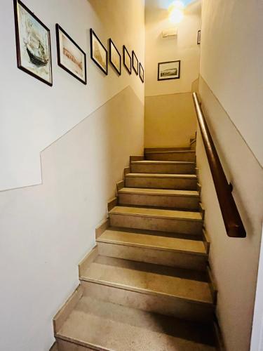 a staircase in a building with some pictures on the wall at Al Cacciatore in Curtatone
