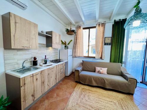 a kitchen with a couch and a sink at da Mumminedda in Cinisi